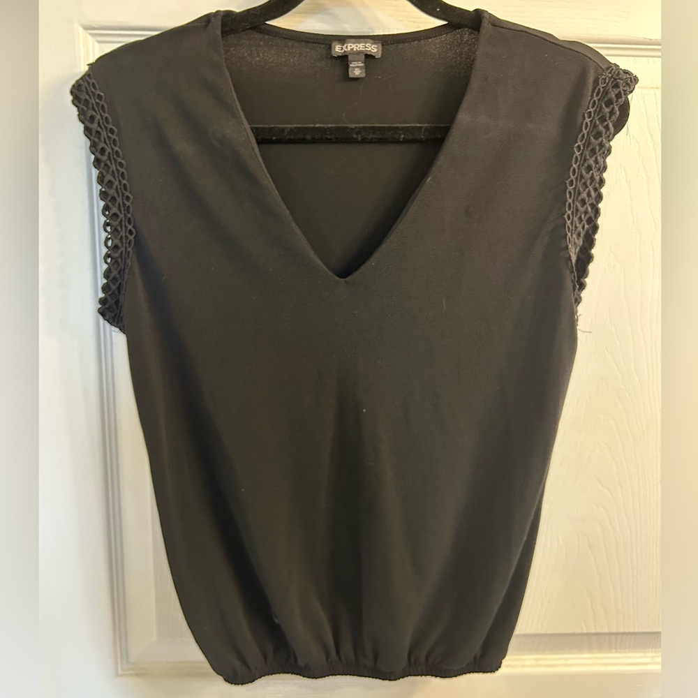 Express black work dress up top with sleeve trim and scrunch bottom